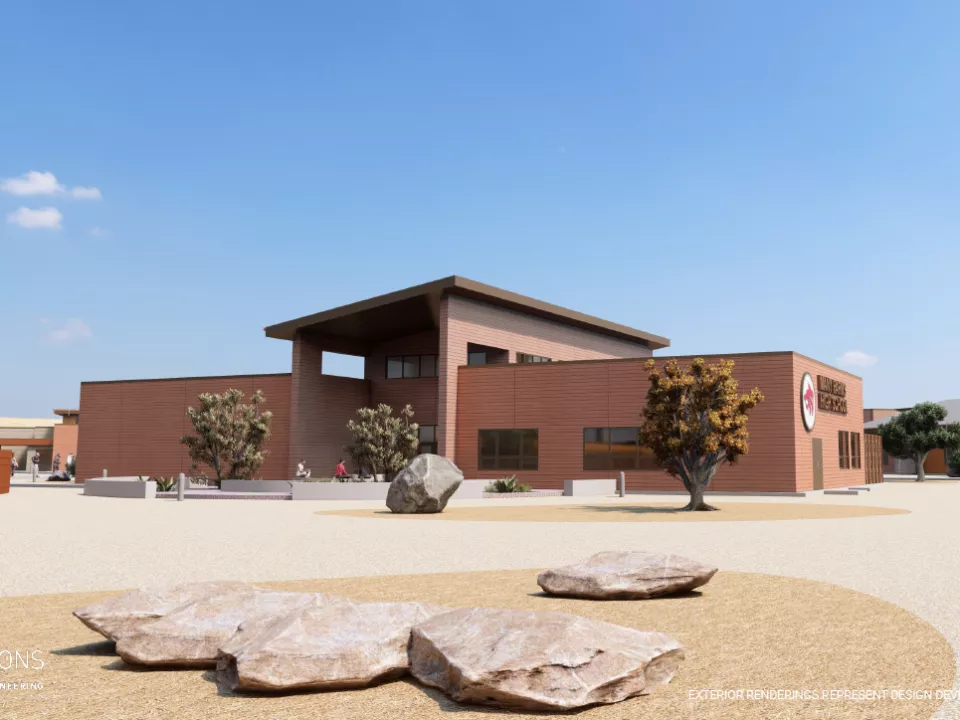 Design rendering of new school building with surrounded by trees and rock landscaping.