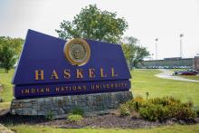Large purple sign with Haskell Indian Nations University in yellow.