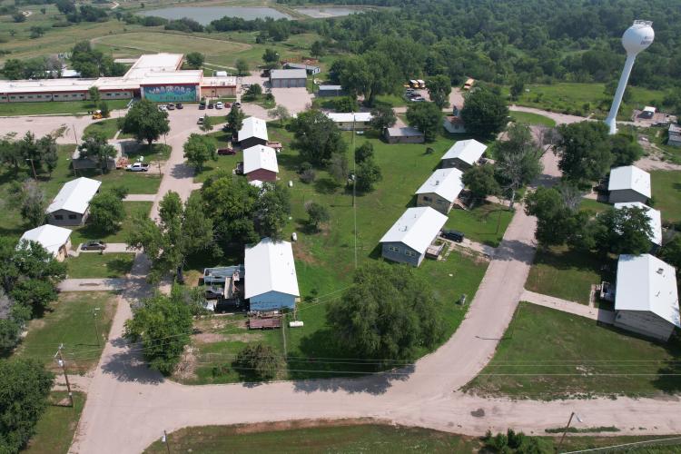 An ariel shot of a school showing all of the different buildings, the paths between them and lots of trees.